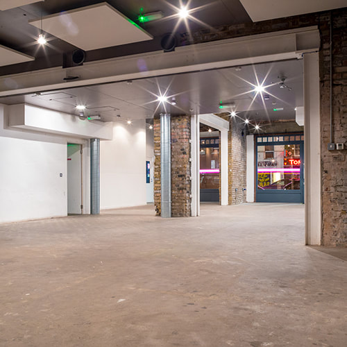 Structural fit-out stage showing the retained original roof timbers and brickwork