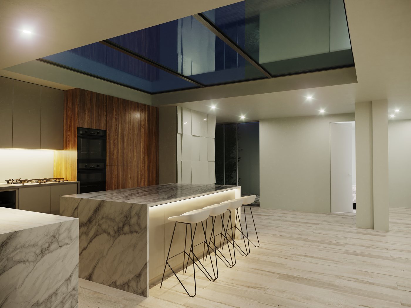 Kitchen at night showing the marble island with under-lit breakfast bar, timber cabinetry and structural skylight open to the night sky