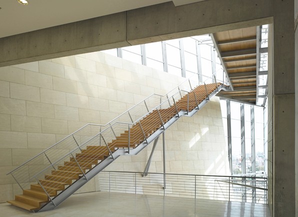 Haifa Supreme Court — timber-treaded stair framed by exposed concrete beams and full-height glazing