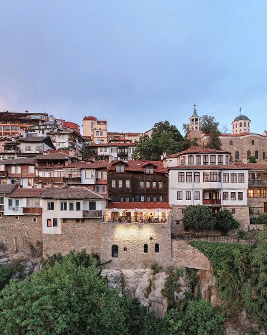 Bridges Residence Boutique Hotel — exterior view of the hillside property at dusk with illuminated terrace, Bulgaria