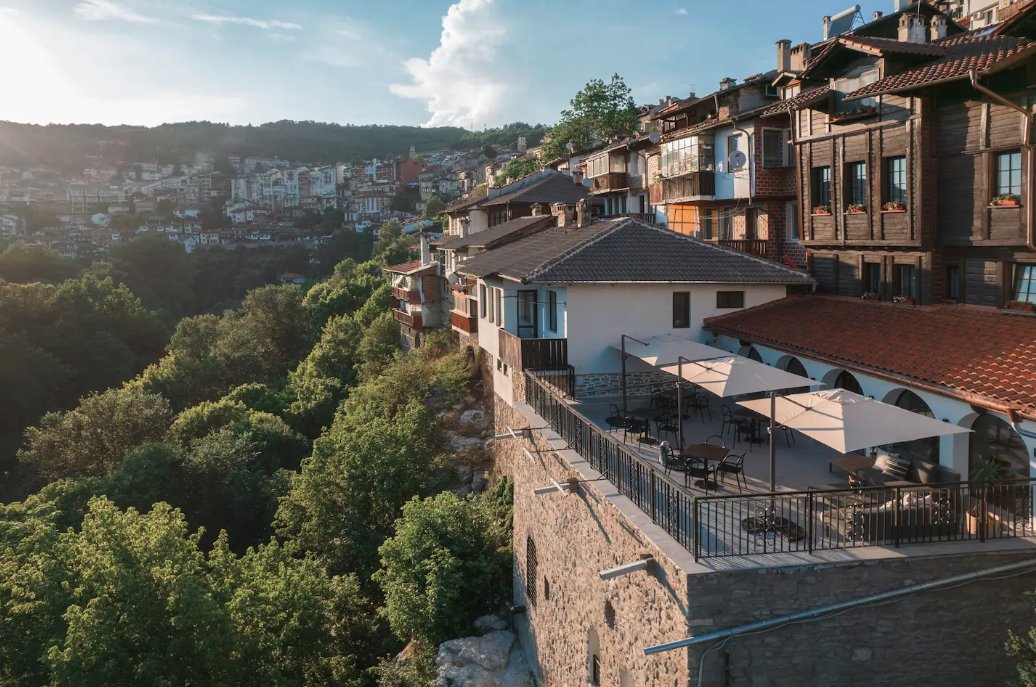 Open-air terrace and dining area at Bridges Residence Boutique Hotel with views over the wooded valley, Bulgaria