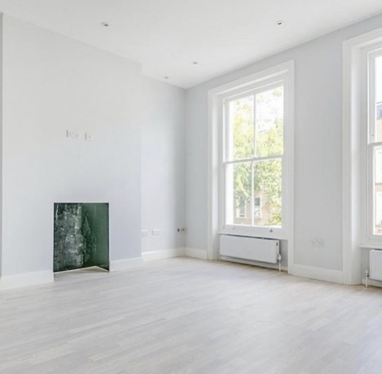 Ifield Road — reception room with restored sash windows, pale engineered oak flooring and a green marble fireplace