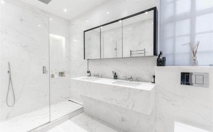 En-suite bathroom finished in White Carrara marble with twin vanity and walk-in shower