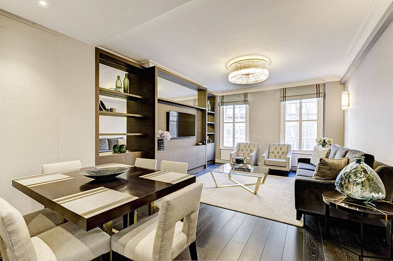 Living and dining area with bespoke dark oak shelving unit and integrated television