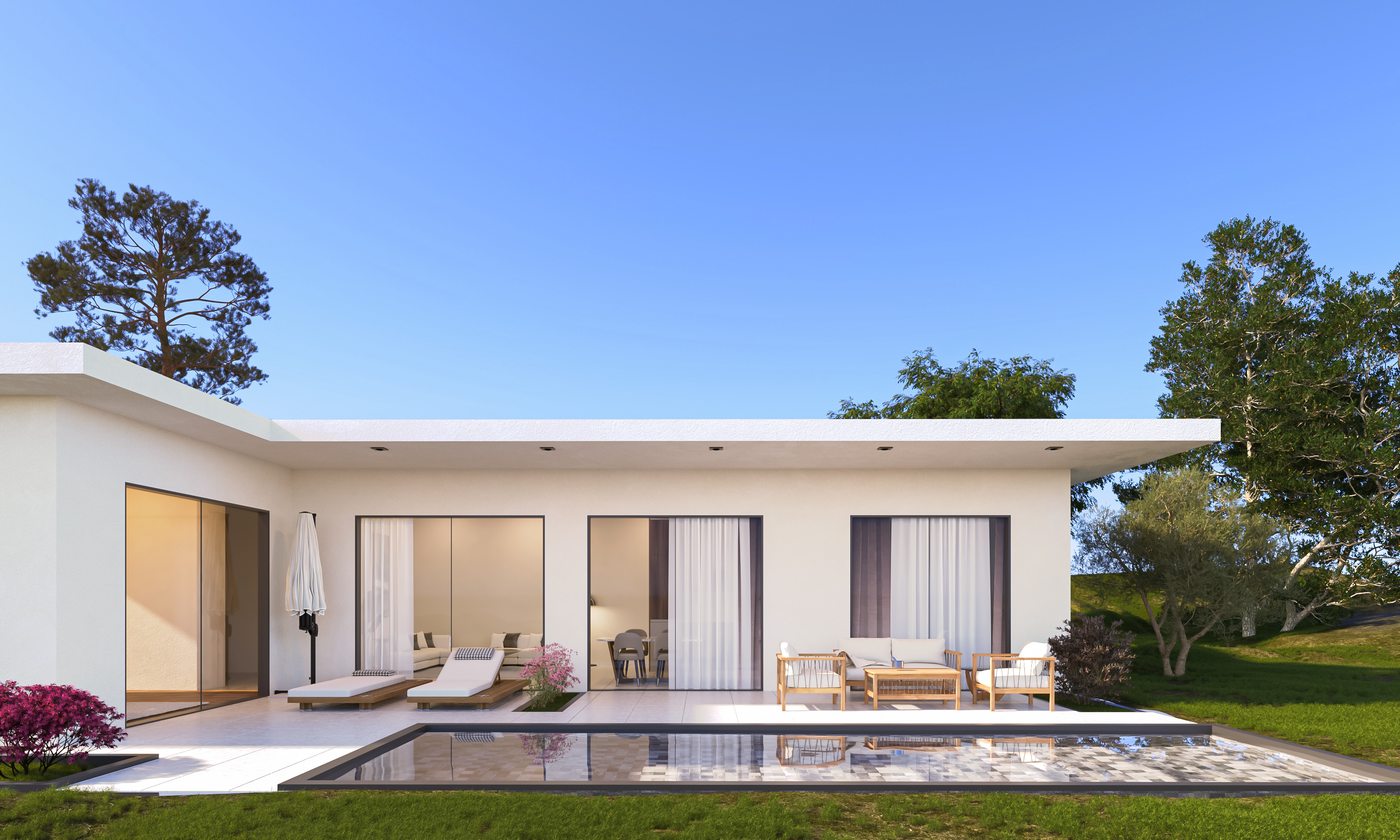 N90 villa exterior by day — white rendered single-storey facade with full-width glazed sliding doors onto the pool terrace