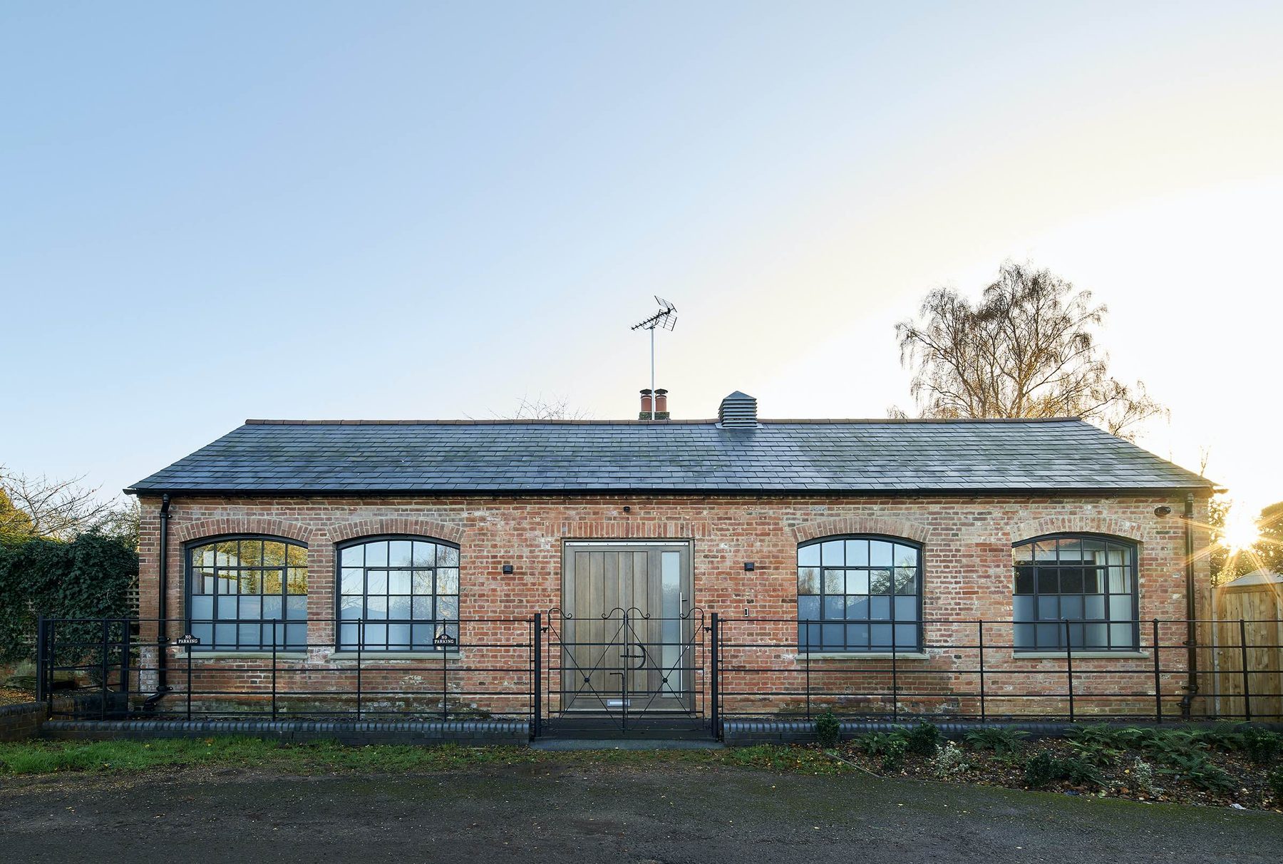 Old Forge — front facade of the converted forge building with arched windows and reclaimed brickwork, Buckinghamshire